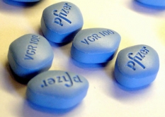 Blue Vagra pills on white background